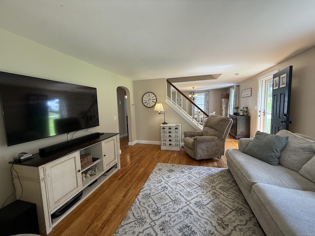 104 Wildcat Hill Rd, Harwinton, CT 06791 - living area with stairway, wood finished floors, arched walkways, and a chandelier