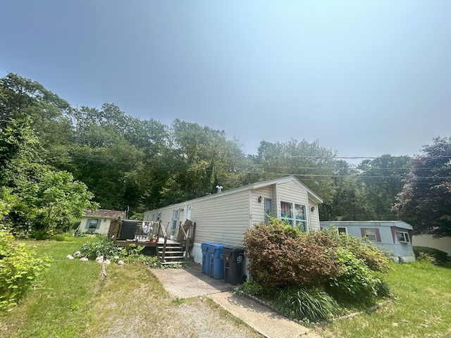 967 Long Cove Rd Trlr 2, Ledyard, CT 06335 - view of property exterior featuring a wooden deck, a lawn, and an outbuilding