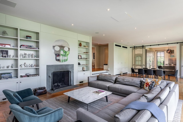 85 W Church Hill Rd, Washington, CT 06794 - living room with wood finished floors, built in shelves, a fireplace, and recessed lighting