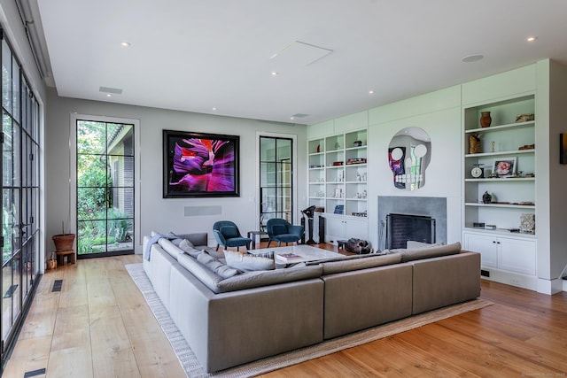 85 W Church Hill Rd, Washington, CT 06794 - living area featuring a fireplace, light wood finished floors, built in shelves, and recessed lighting