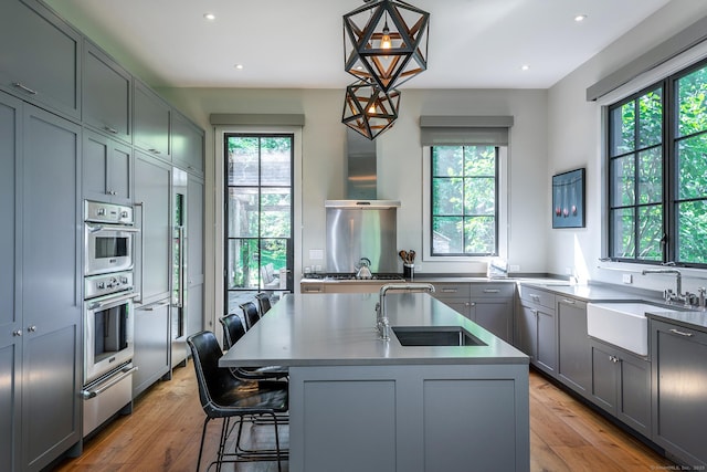 85 W Church Hill Rd, Washington, CT 06794 - kitchen featuring healthy amount of natural light, gray cabinets, a center island with sink, a warming drawer, and recessed lighting