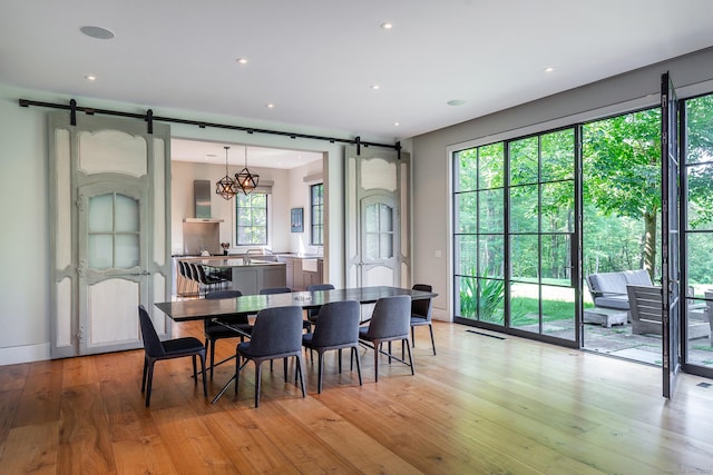 85 W Church Hill Rd, Washington, CT 06794 - dining area with a barn door, light wood-style flooring, and recessed lighting