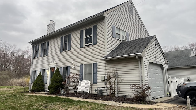 761 Lydall St, Manchester, CT 06042 - view of side of property with a chimney and a garage