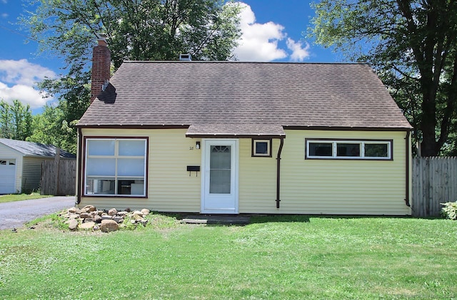 28 Chester Ln, Wallingford, CT 06492 - view of front of property featuring a chimney, a shingled roof, and an outdoor structure