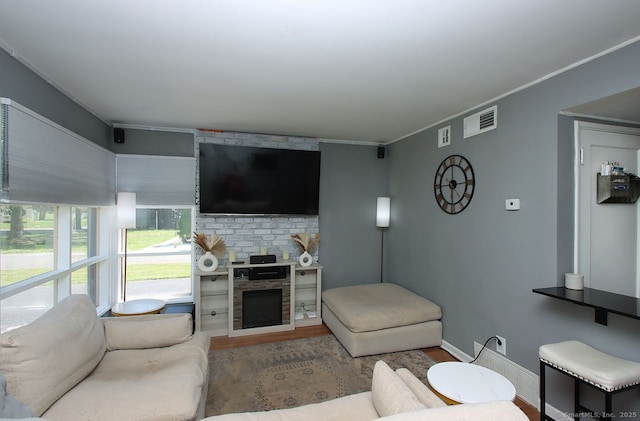 28 Chester Ln, Wallingford, CT 06492 - living room with wood finished floors, crown molding, and a fireplace