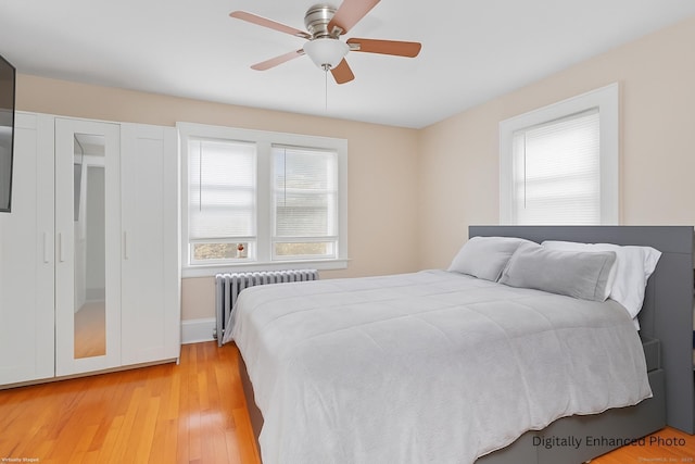 96 Kenwood Ave, Fairfield, CT 06824 - bedroom featuring radiator heating unit, light wood-style floors, and ceiling fan