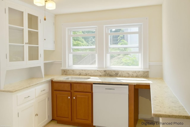 96 Kenwood Ave, Fairfield, CT 06824 - kitchen with white dishwasher, light stone countertops, and white cabinets