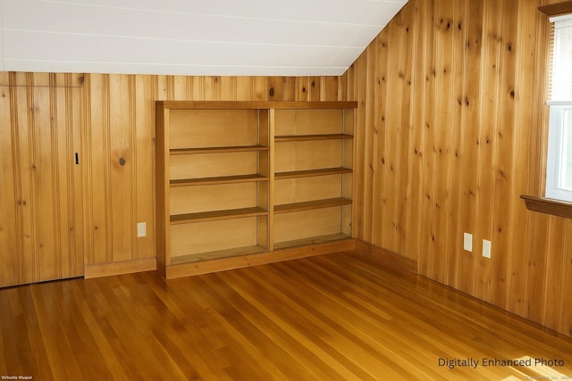 96 Kenwood Ave, Fairfield, CT 06824 - unfurnished bedroom featuring wood walls, wood finished floors, a closet, and multiple windows