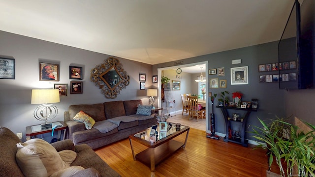 345 Goodwin St, East Hartford, CT 06108 - living room featuring wood-type flooring and a chandelier