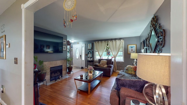 345 Goodwin St, East Hartford, CT 06108 - living area featuring hardwood / wood-style flooring and a tiled fireplace