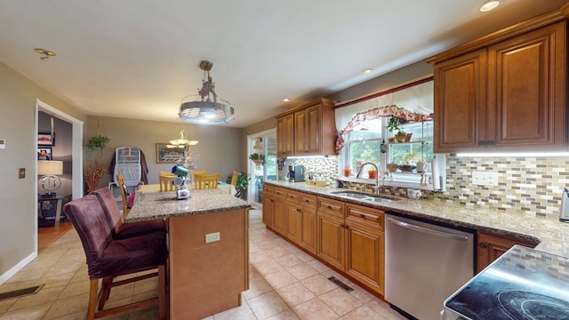 345 Goodwin St, East Hartford, CT 06108 - kitchen featuring stainless steel dishwasher, a center island, light stone counters, light tile patterned flooring, and recessed lighting