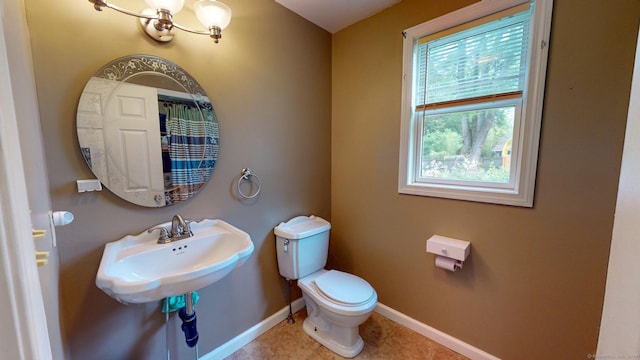 345 Goodwin St, East Hartford, CT 06108 - bathroom with tile patterned floors and a chandelier