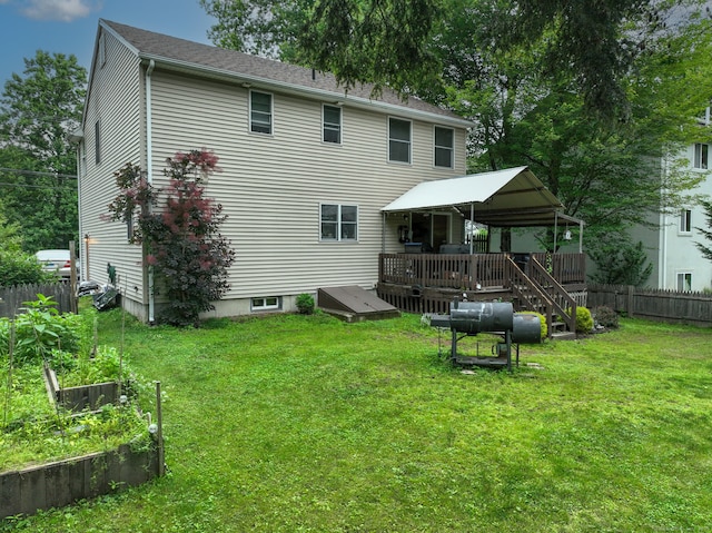 345 Goodwin St, East Hartford, CT 06108 - rear view of house featuring a deck, a vegetable garden, and oil tank