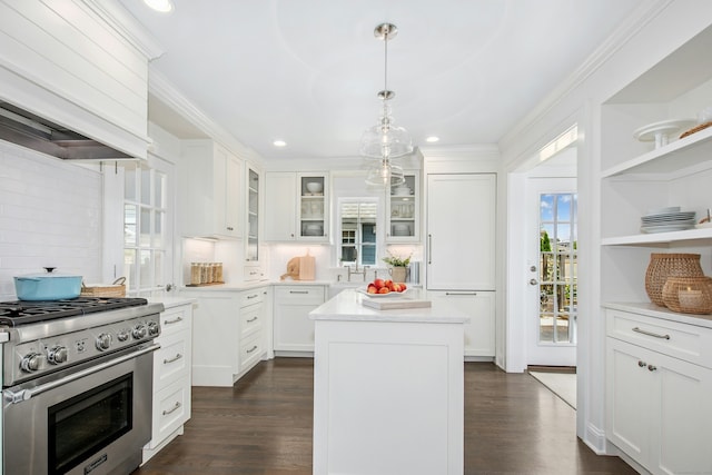 18 Wallace Ave, Norwalk, CT 06855 - kitchen with stainless steel stove, custom range hood, white cabinetry, light countertops, and ornamental molding