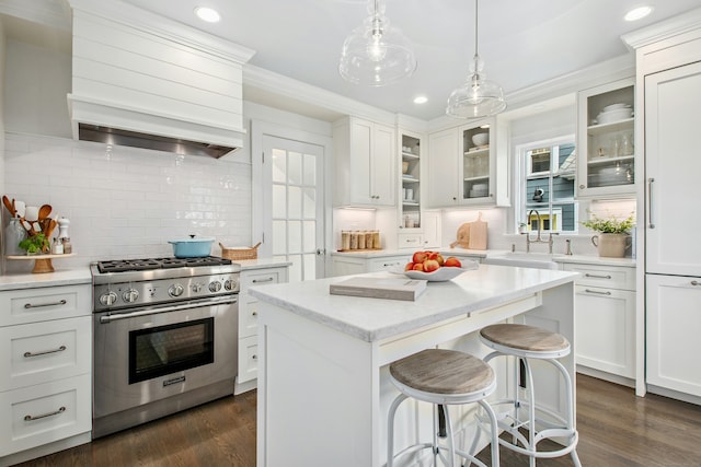 18 Wallace Ave, Norwalk, CT 06855 - kitchen with high end range, custom range hood, decorative backsplash, recessed lighting, and white cabinets