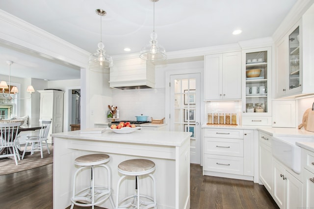 18 Wallace Ave, Norwalk, CT 06855 - kitchen with premium range hood, dark wood-type flooring, backsplash, white cabinets, and recessed lighting