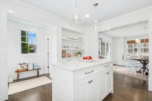 18 Wallace Ave, Norwalk, CT 06855 - kitchen with dark wood finished floors, plenty of natural light, white cabinetry, light countertops, and crown molding