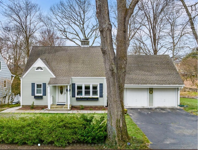 15 Granite Ter, Ansonia, CT 06401 - new england style home with a chimney, asphalt driveway, a shingled roof, and an attached garage