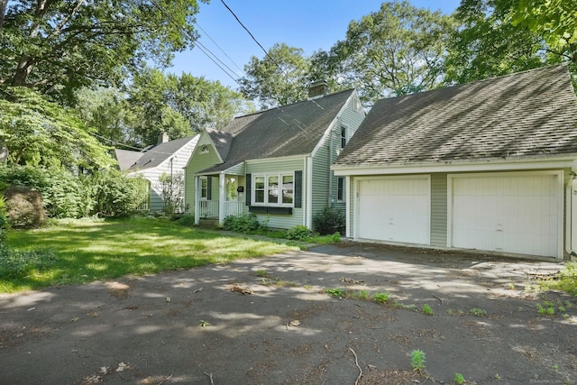 15 Granite Ter, Ansonia, CT 06401 - new england style home with a garage, a chimney, and a front yard