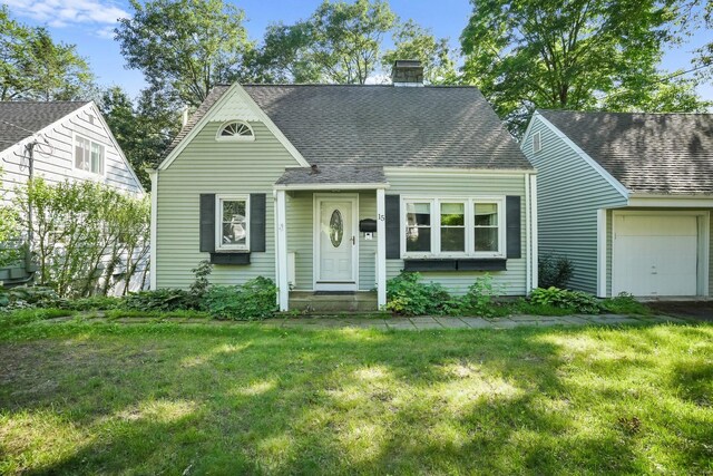 15 Granite Ter, Ansonia, CT 06401 - view of front facade featuring a front lawn, roof with shingles, and a chimney