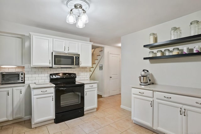 15 Granite Ter, Ansonia, CT 06401 - kitchen featuring stainless steel microwave, electric range, tasteful backsplash, and light countertops