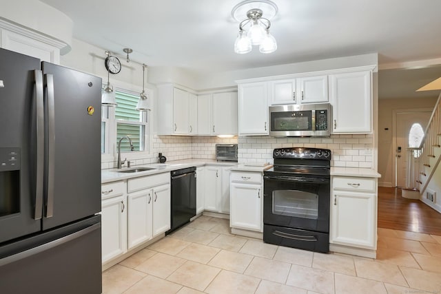 15 Granite Ter, Ansonia, CT 06401 - kitchen with black appliances, light countertops, tasteful backsplash, and white cabinets