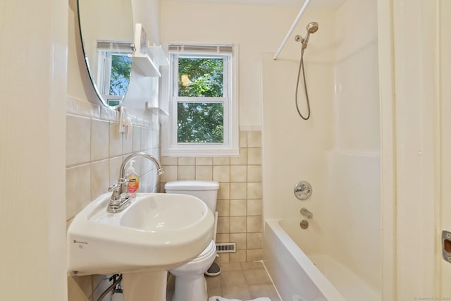 15 Granite Ter, Ansonia, CT 06401 - bathroom featuring tile walls, tile patterned flooring, bathtub / shower combination, and a wainscoted wall