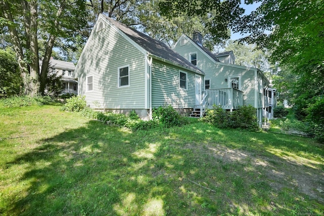 15 Granite Ter, Ansonia, CT 06401 - view of side of property featuring a chimney, a deck, and a yard