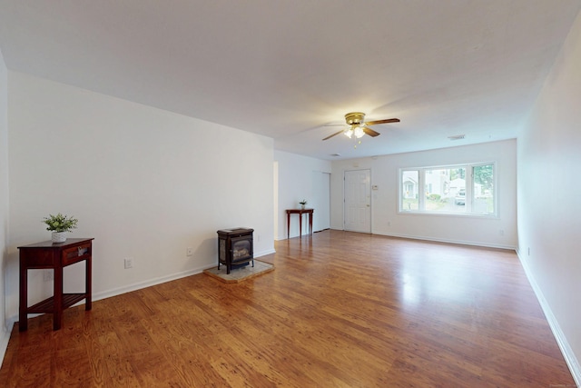 20 Hickory St, Danbury, CT 06810 - unfurnished living room with a wood stove, ceiling fan, and wood finished floors