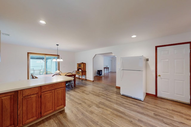 20 Hickory St, Danbury, CT 06810 - kitchen featuring freestanding refrigerator, arched walkways, light wood finished floors, light countertops, and recessed lighting