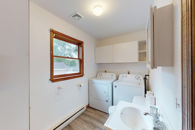 20 Hickory St, Danbury, CT 06810 - washroom with washing machine and dryer, light wood-type flooring, and a baseboard heating unit