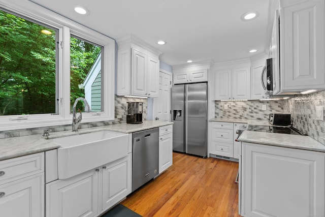 212 Richards Ave Apt 6, Norwalk, CT 06850 - kitchen with stainless steel appliances, white cabinets, tasteful backsplash, light wood-style flooring, and recessed lighting