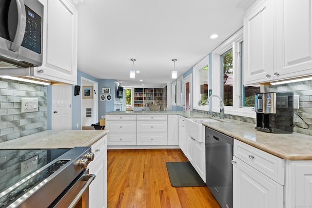 212 Richards Ave Apt 6, Norwalk, CT 06850 - kitchen featuring stainless steel appliances, plenty of natural light, decorative backsplash, light wood-style floors, and recessed lighting