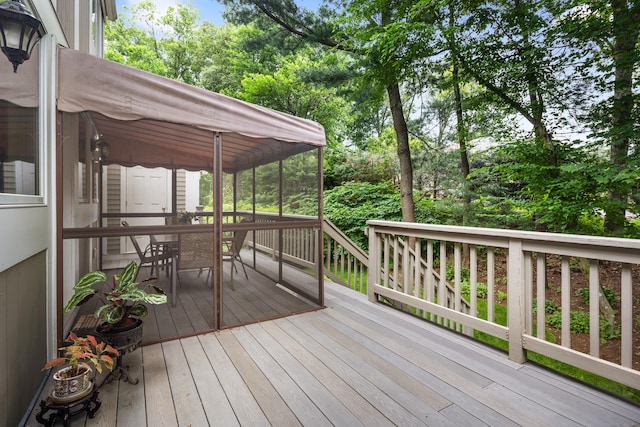 212 Richards Ave Apt 6, Norwalk, CT 06850 - wooden terrace with a sunroom, outdoor dining space, and view of scattered trees