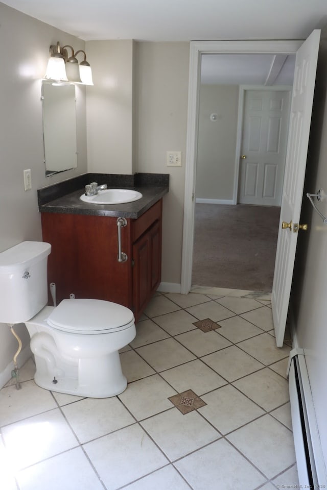 51 Main St, Thompson, CT 06255 - half bath featuring a baseboard radiator, vanity, and tile patterned floors