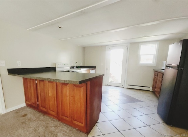 51 Main St, Thompson, CT 06255 - kitchen featuring freestanding refrigerator, a peninsula, a baseboard radiator, brown cabinets, and range