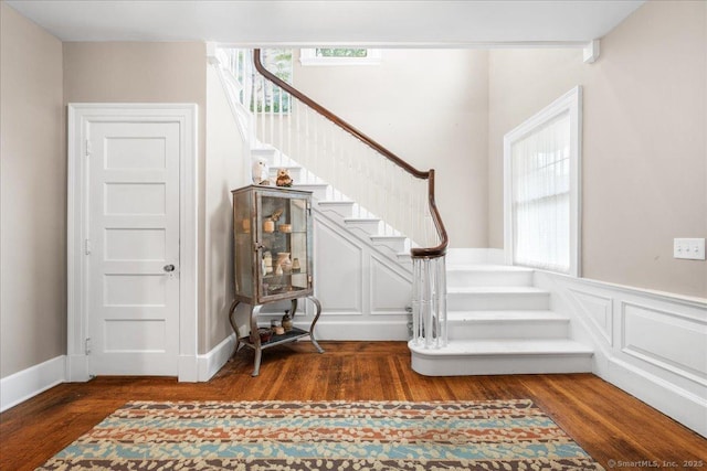 20 Channing St, New London, CT 06320 - stairs featuring wood finished floors, plenty of natural light, a wainscoted wall, and a decorative wall