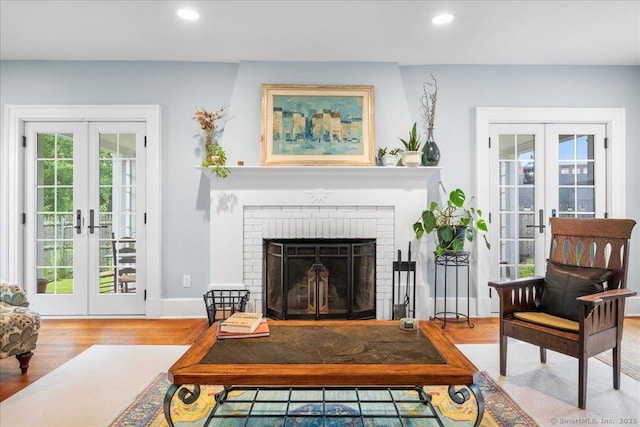 20 Channing St, New London, CT 06320 - living room featuring french doors, healthy amount of natural light, wood finished floors, recessed lighting, and a brick fireplace