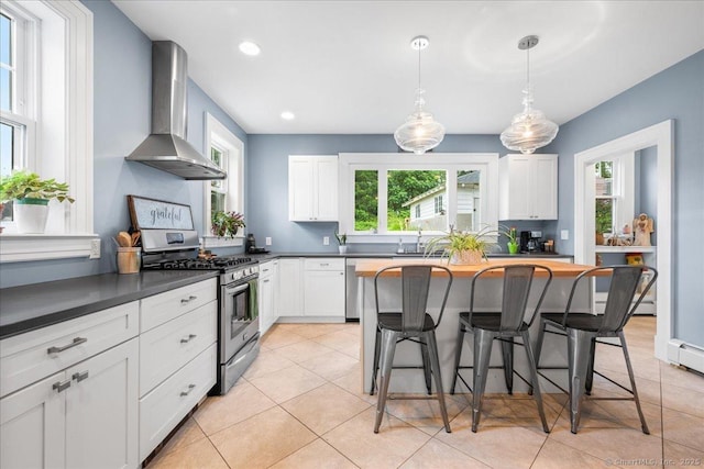 20 Channing St, New London, CT 06320 - kitchen featuring stainless steel appliances, wall chimney range hood, a kitchen bar, white cabinetry, and light tile patterned flooring