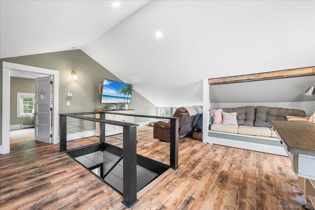 20 Channing St, New London, CT 06320 - living area featuring wood finished floors, vaulted ceiling, and a baseboard radiator
