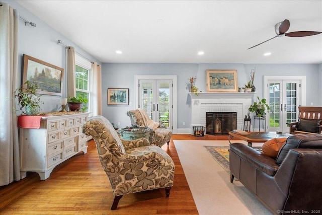 20 Channing St, New London, CT 06320 - living room with french doors, light wood-style flooring, a fireplace, recessed lighting, and a ceiling fan