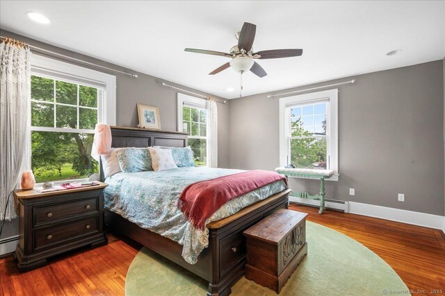 20 Channing St, New London, CT 06320 - bedroom with a baseboard radiator, wood finished floors, ceiling fan, and recessed lighting