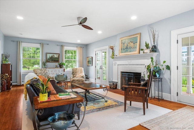 20 Channing St, New London, CT 06320 - living room with a ceiling fan, wood finished floors, a fireplace, recessed lighting, and baseboard heating