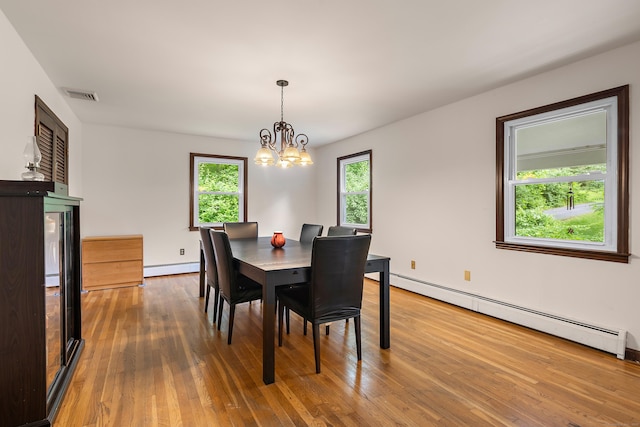 205 Luther Dr, Southbury, CT 06488 - dining area with a baseboard heating unit, plenty of natural light, and a chandelier