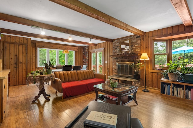 205 Luther Dr, Southbury, CT 06488 - living area with beamed ceiling, wooden walls, light wood-style floors, and a fireplace