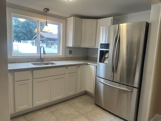 27 Woodbridge Ave, East Hartford, CT 06108 - kitchen with stainless steel fridge with ice dispenser, white cabinets, light tile patterned floors, and light stone countertops