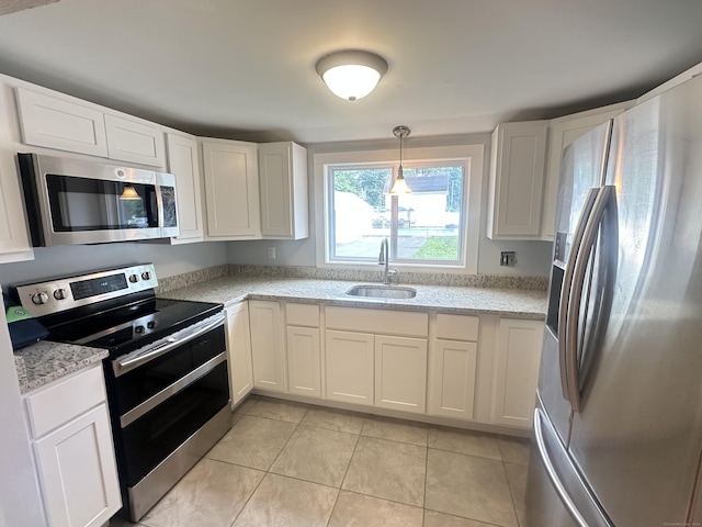 27 Woodbridge Ave, East Hartford, CT 06108 - kitchen featuring stainless steel appliances, white cabinets, light tile patterned floors, and light stone counters