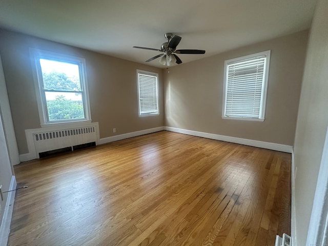 27 Woodbridge Ave, East Hartford, CT 06108 - spare room featuring radiator, wood finished floors, and ceiling fan