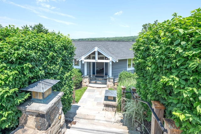 100 N Lake Shore Dr, Brookfield, CT 06804 - view of front facade featuring a shingled roof and stone siding