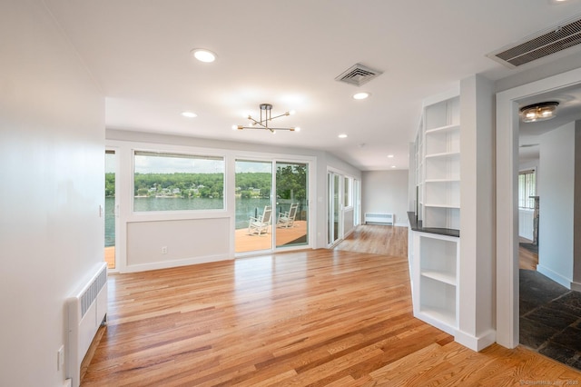 100 N Lake Shore Dr, Brookfield, CT 06804 - unfurnished living room featuring radiator, a chandelier, light wood-type flooring, and recessed lighting